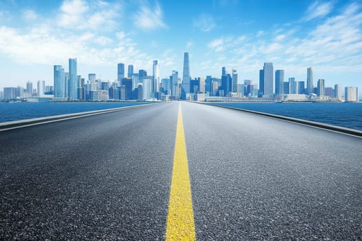 A captivating view of an expansive road leading towards a stunning urban skyline, framed by bright blue skies and shimmering water, ideal for travel themes.