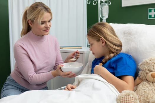 A caring moment between a mother and her daughter, showcasing love and support in a hospital setting.