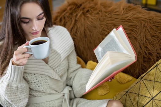 A tranquil and serene scene of pure relaxation with a woman savoring her coffee while engrossed in a fascinating book