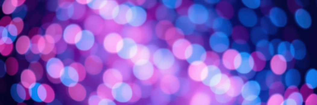 A vibrant and colorful abstract background features soft bokeh lights in shades of blue and pink, creating a festive atmosphere ideal for celebrations or gatherings at night.