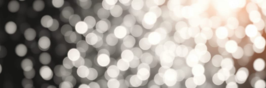 Enchanting bokeh lights twinkle against a dark background, creating a magical ambiance during a nighttime celebration, perfect for special events and gatherings.