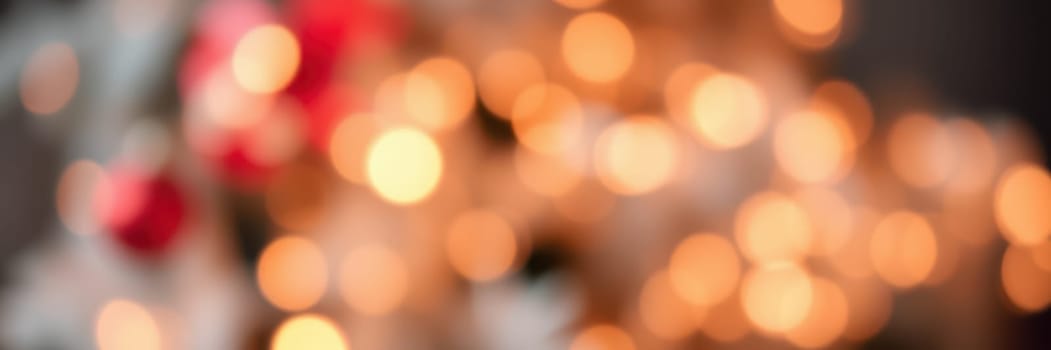 Soft, glowing lights shimmer in a blurred background, evoking a warm holiday spirit in a cozy indoor space during winter festivities.