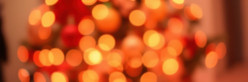 Colorful lights sparkle throughout a decorated tree, creating a festive ambiance perfect for winter celebrations. The soft glow adds warmth to the holiday spirit.