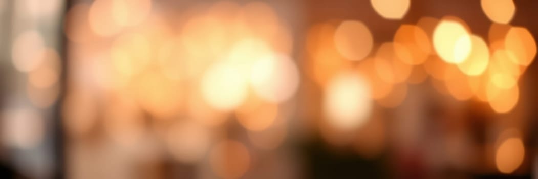 Soft golden lights illuminate a cozy space, creating a warm and inviting ambiance as patrons engage in lively conversations at a cafe in the evening.