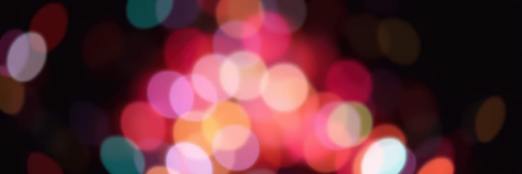 Bright, blurred lights in shades of pink, orange, and green create a dynamic, festive atmosphere. The scene captures the essence of celebration, enhancing the joyful ambiance.
