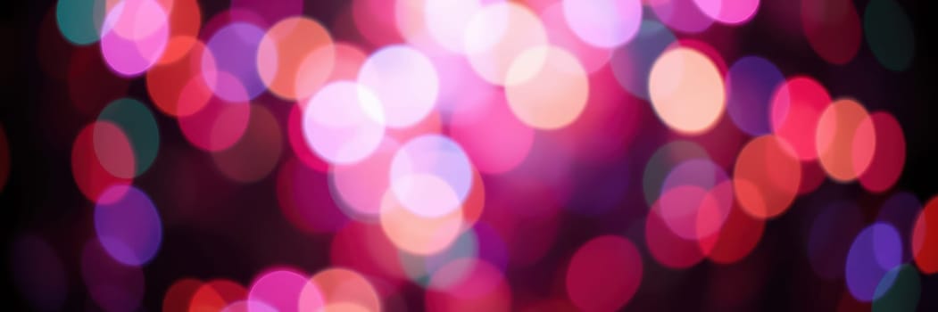 A dazzling display of colorful bokeh lights fills the background, enhancing the festive atmosphere of a lively nighttime event in the city, evoking excitement and joy.