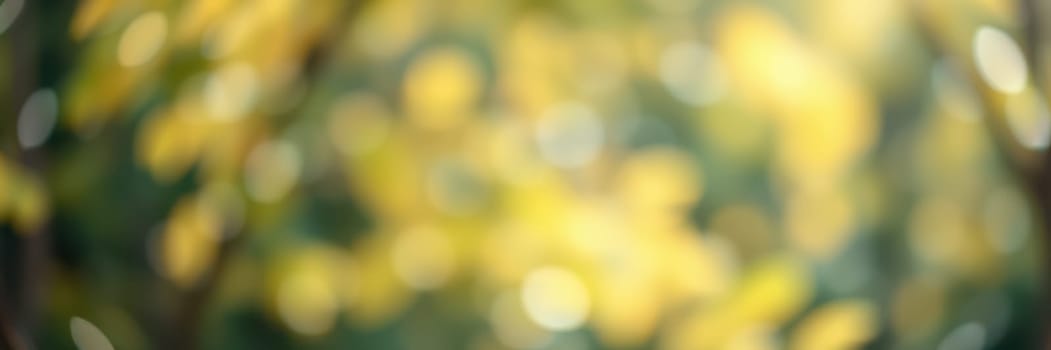 Vivid golden leaves shimmer softly in the sunlight, creating a soothing blur through which sunlight filters, capturing the essence of a tranquil autumn day in the park.