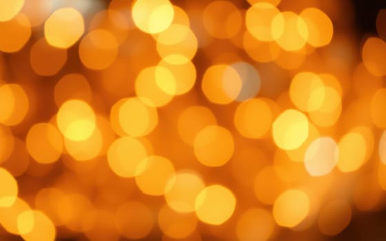 Soft golden lights fill the atmosphere, creating a beautiful bokeh effect that enhances the festive mood during an outdoor evening gathering with friends.