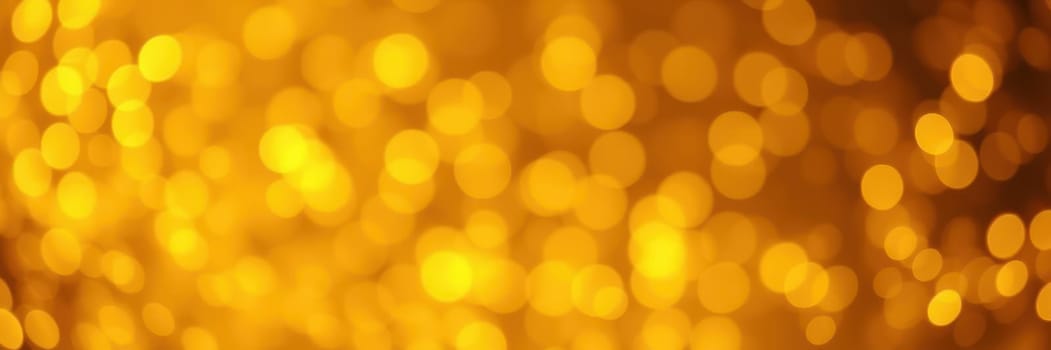 A collection of golden bokeh lights creates a vibrant and festive atmosphere, enhancing the mood for celebrations such as parties or holidays. The luminous glow captivates the viewer.