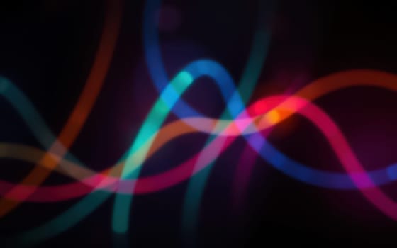 Vibrant flowing lines of blue, pink, and purple swirl together to create an abstract design, radiating color and energy in a night time setting.