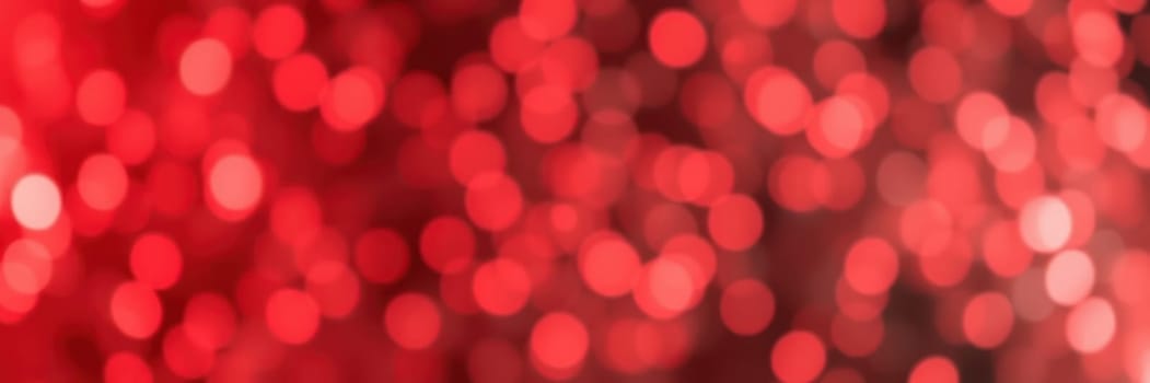 Soft red bokeh lights fill the background, creating a warm and inviting atmosphere perfect for evening festivities. The blurred effect adds depth, enhancing the festive mood.