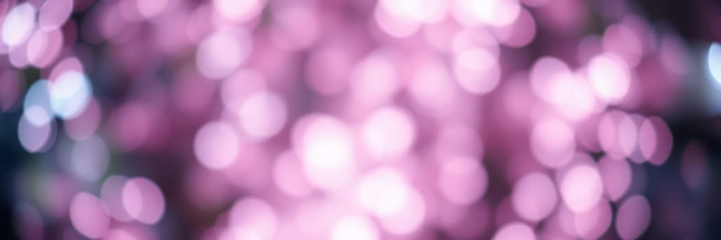 Soft, out-of-focus lights in warm pink hues create a whimsical vibe, enhancing the festive atmosphere of an evening gathering among friends and family.