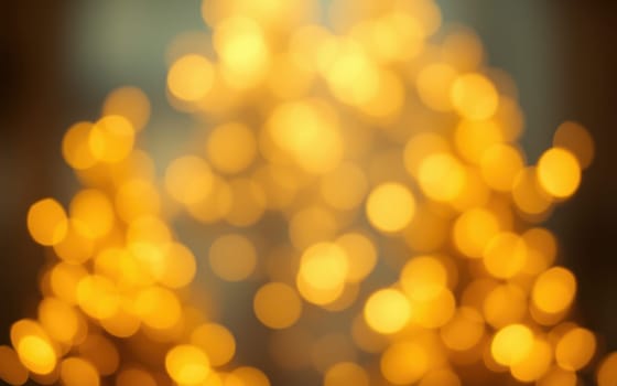 A beautiful display of soft golden lights fills the indoor area, casting a warm glow and creating a festive atmosphere during the holiday season with blurred visuals.