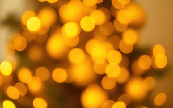 A blurred arrangement of golden bokeh lights fills the background, evoking a cozy and festive mood perfect for celebrating the holiday season.