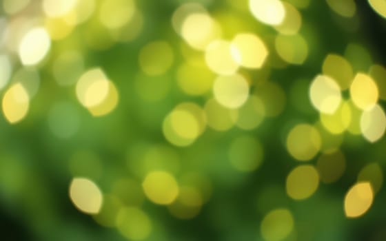 Sunlight dances through lush green leaves, creating a beautiful bokeh effect with numerous glowing spots of light. The vibrant colors evoke a tranquil summer atmosphere.