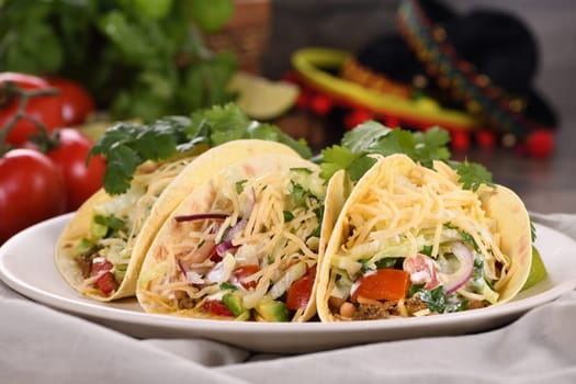 Taco with ground beef and avocado, cabbage and cheese. Mexican cuisine. Close-up.