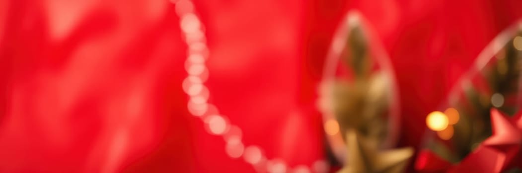 Colorful decorative elements including shiny ornaments and beads adorn a vibrant red backdrop, creating a lively and festive mood for a special event or celebration.