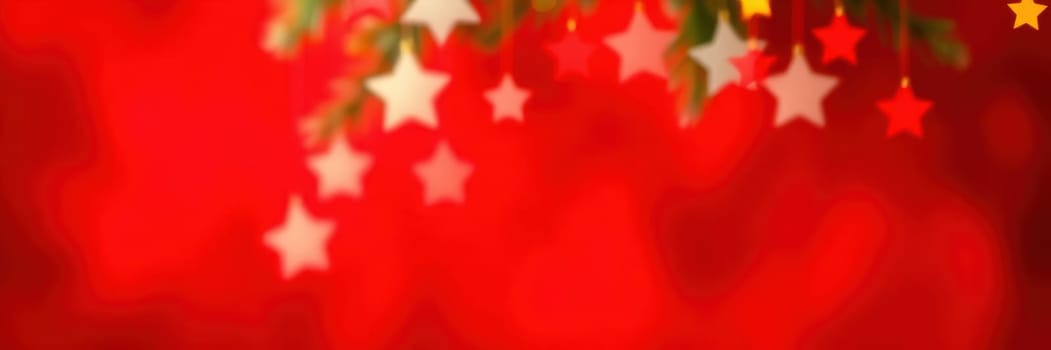 Brightly colored stars dangle against a red backdrop, creating a joyful atmosphere typical of festive seasons. This decoration adds cheer to holiday events.