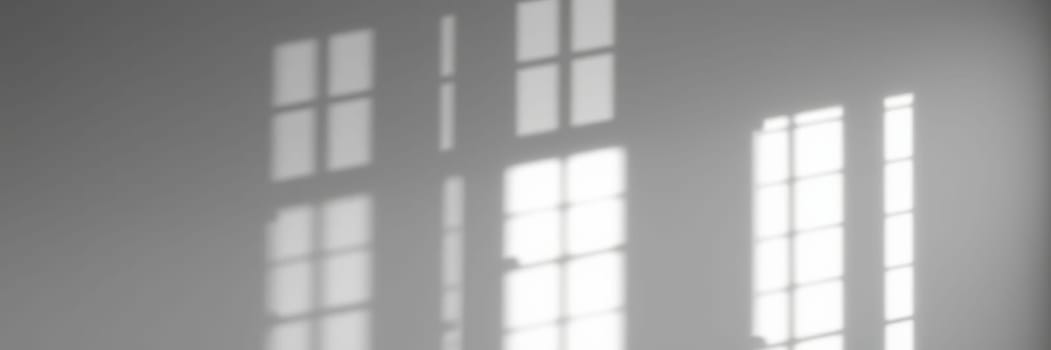 Sunlight filters through multiple window panes, creating soft shadows on a wall in a serene indoor environment during the early morning hours.