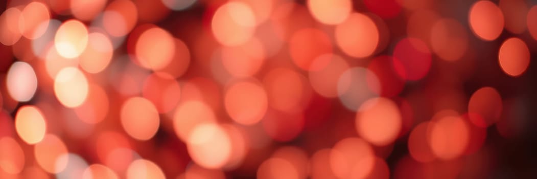 Vibrant red bokeh lights shimmer softly, enhancing the festive atmosphere at an evening event, casting a warm glow and inviting ambiance for guests.