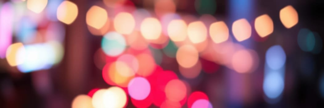 Bright, colorful bokeh lights fill the urban setting, creating a vibrant and dynamic atmosphere during the evening hours. The street is alive with energy and excitement.