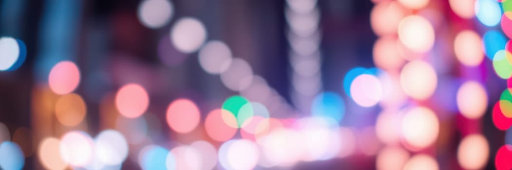 Vibrant city lights create a lively atmosphere on an urban street at night, showcasing a mesmerizing display of colorful bokeh effects in the background.