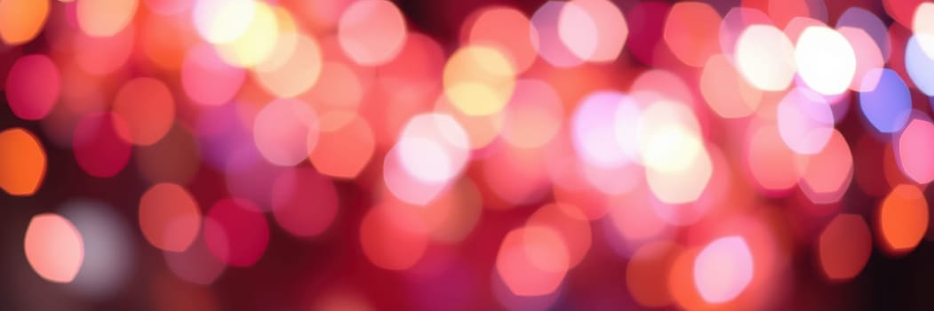 Soft, colorful lights illuminate the night as people gather to celebrate. The vibrant bokeh effect adds a magical touch to the lively atmosphere, enhancing the joy of the event.