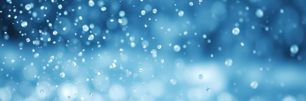 Bright blue background showcases numerous water droplets, creating a mesmerizing sparkling effect. The peaceful scene evokes the refreshing atmosphere of a rainy day.