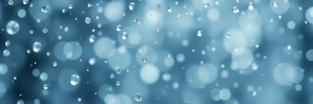 Raindrops gently fall, creating a soothing ambiance as they scatter light. The blue background enhances the calming effect, evoking a sense of peace and reflection.