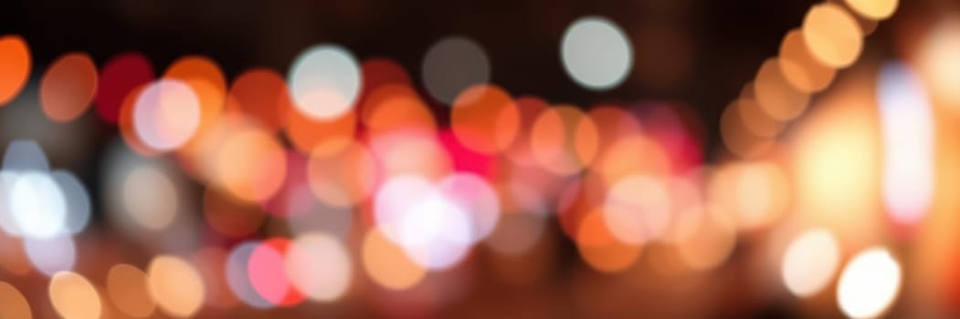 Bright lights blur together, creating a lively atmosphere in a bustling urban street during twilight. The warm and cool hues of the lights enhance the nightlife vibe.