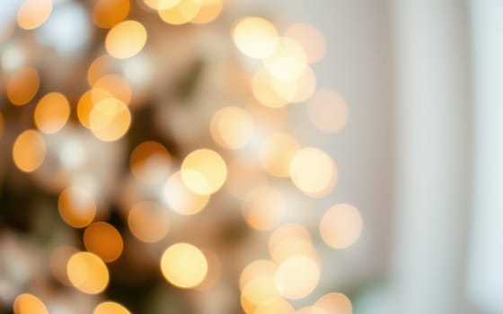 A blurred background of shimmering golden bokeh lights creates a festive and warm atmosphere in a cozy indoor space, ideal for winter celebrations and gatherings.