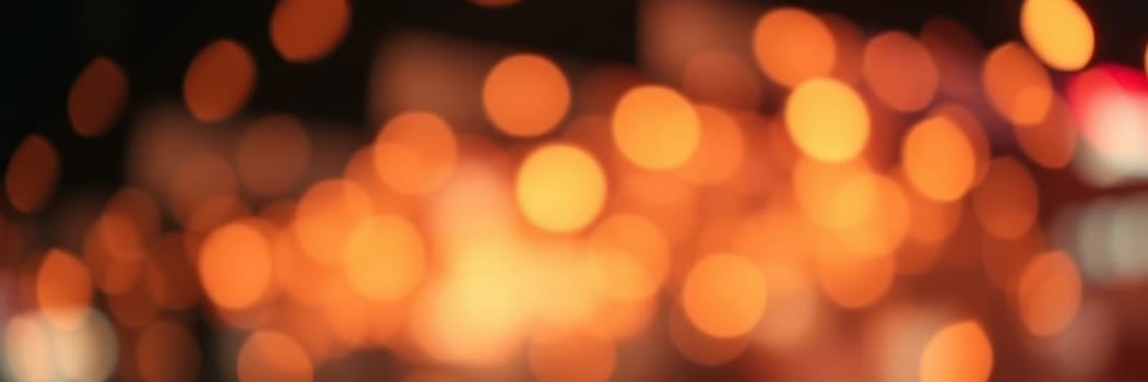 Soft and warm bokeh lights create a magical atmosphere at an evening gathering in a lively urban location. The blurred lights highlight the festive mood and energy of the surroundings.