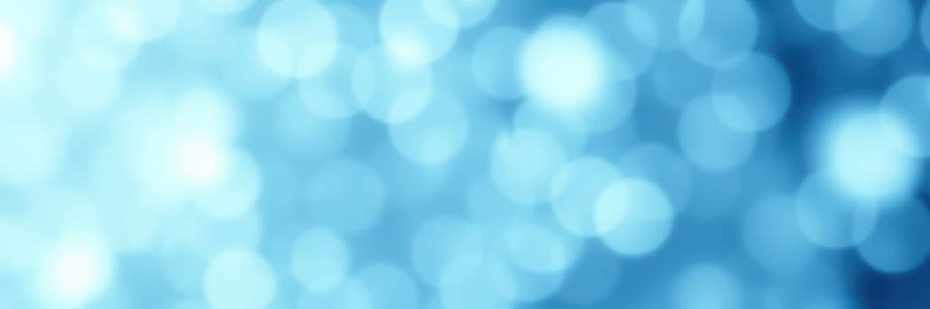 Soft blue circles of light create a tranquil background effect ideal for artistic projects. The blurred shapes enhance visual appeal, adding a serene touch to designs.