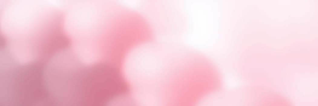 Delicate pink flowers bloom under warm sunlight, creating a serene atmosphere in a tranquil garden. Spring brings vibrant colors and refreshing scents to the surroundings.