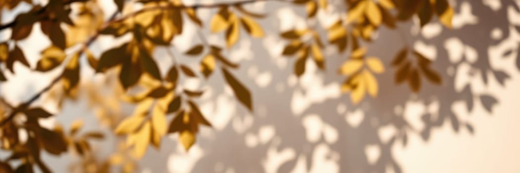 Golden leaves gently sway in the breeze, creating delicate shadows on a warm sunlit wall, capturing the essence of a serene autumn day outdoors.