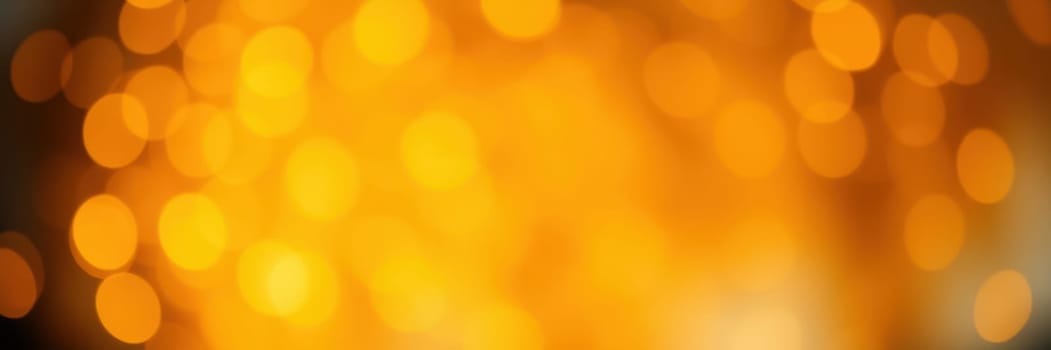 A soft, glowing background of golden bokeh lights adds a festive and cozy ambiance to an evening event, enhancing the atmosphere for celebration and connection among guests.