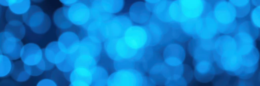 Soft blue lights are scattered in a stunning bokeh effect, enhancing the festive ambiance of a nighttime event filled with joy and excitement, inviting everyone to enjoy the moment.