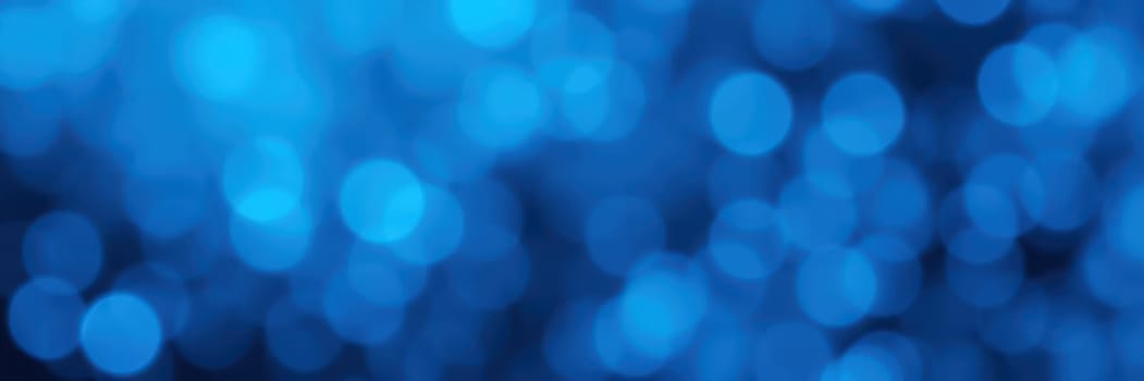 Swirling blue hues create a lively background filled with soft, luminous bokeh lights, evoking a sense of energy and creativity. Ideal for artistic projects or designs.