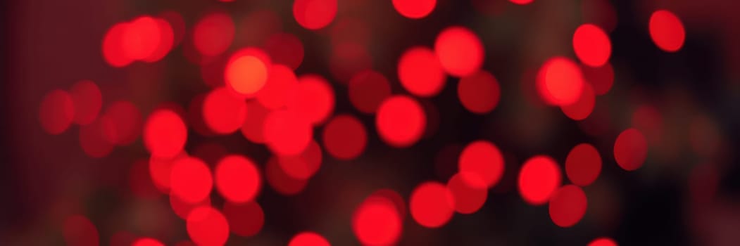 Strings of bright red lights fill the background, creating a cozy ambiance perfect for a joyful evening gathering or celebration with friends and family.
