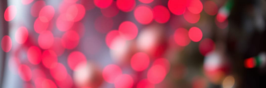 Bright red lights create a lively atmosphere at a festive event in the city center, drawing crowds to enjoy the cheerful environment and celebration.