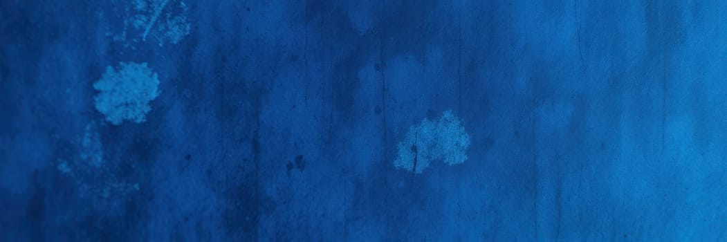Deep blue colors blend seamlessly on the surface, showcasing rich textures and subtle variations that create a striking visual interest. The interplay of light adds depth to the design.