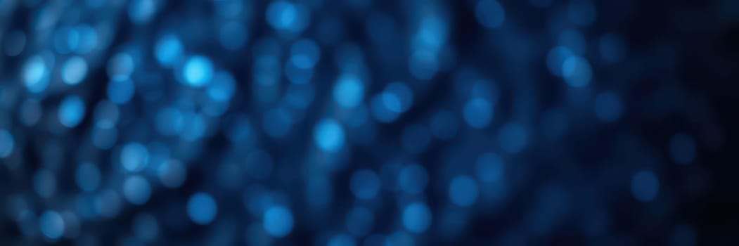 Soft blue bokeh lights sparkle in a blurred background, creating a tranquil and mesmerizing ambiance. Ideal for conveying feelings of serenity and calmness, this visual evokes a sense of peace.