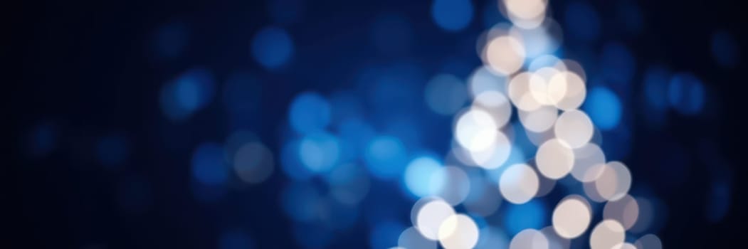 Colorful bokeh lights shimmer softly, evoking a festive mood during the winter season. The blurred effect enhances the warmth and charm of the holiday ambiance.