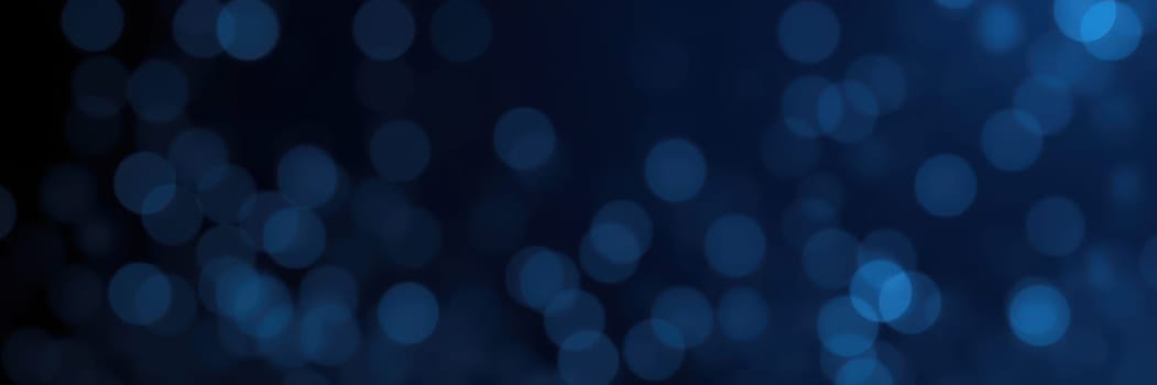 A captivating display of blue bokeh lights fills the dark background, creating a magical ambiance perfect for nighttime gatherings and celebrations. The soft glows provide a serene backdrop.
