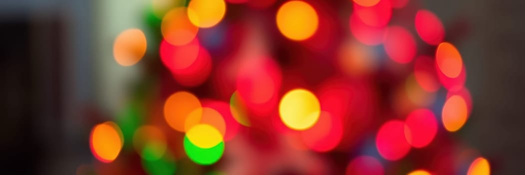 Brightly colored lights adorn a Christmas tree, illuminating the cozy indoor space where family members enjoy a joyful winter gathering filled with laughter and warmth.