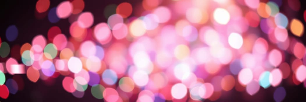 Bright, vibrant bokeh lights illuminate the dark surroundings, creating a festive and joyful ambiance during a nighttime celebration event, perfect for gatherings.
