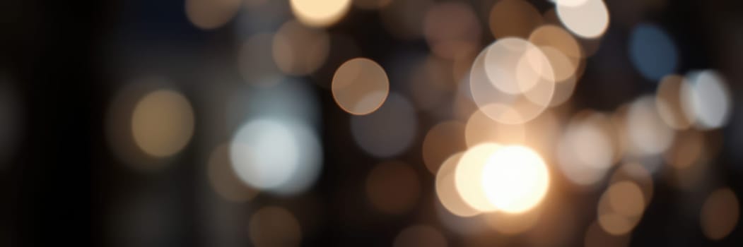 A multitude of circular bokeh lights softly illuminates the scene, creating a warm and enchanting ambiance as evening descends. The blurred background enhances the magic.