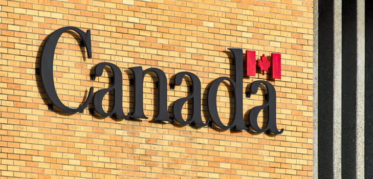Canada. Name of the country on brick wall background.