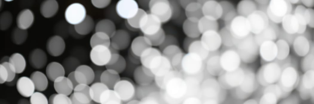 Delicate light spots blend together, forming a mesmerizing bokeh effect with a black background. The soft textures and variations create a dreamy atmosphere.