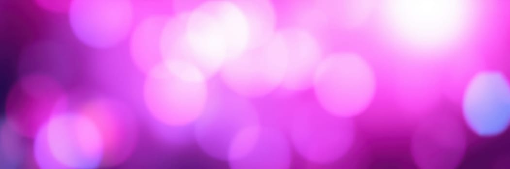 A mesmerizing display of pink and purple bokeh lights fills the atmosphere, enhancing the festive mood of an indoor celebration. Soft glows radiate warmth and excitement.
